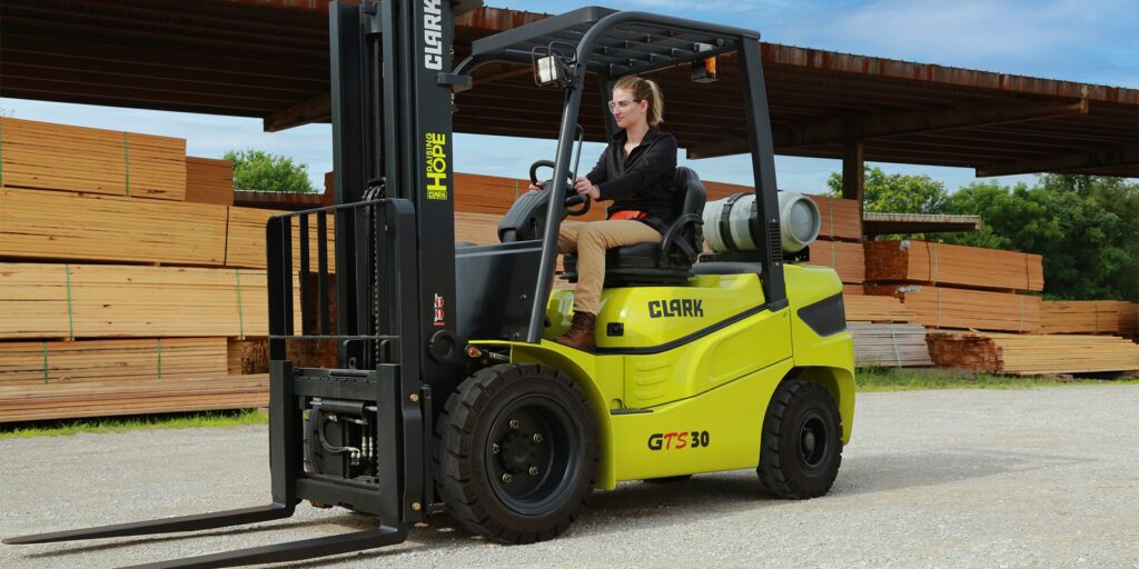 A woman driving a forklift